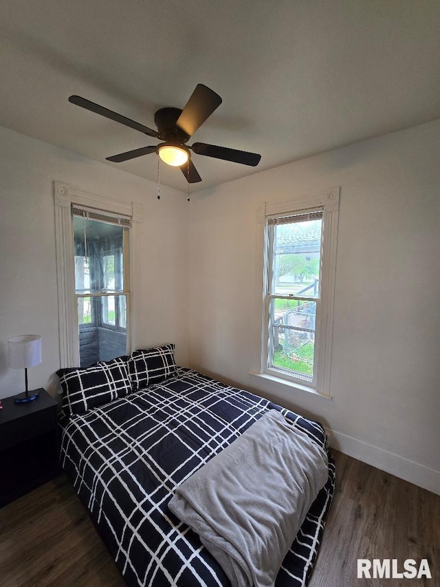 818 16th Ave, Fulton, IL 61252 - bedroom with baseboards, multiple windows, a ceiling fan, and wood finished floors