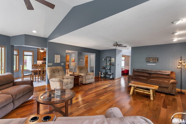living area featuring baseboards, ceiling fan, wood finished floors, and lofted ceiling