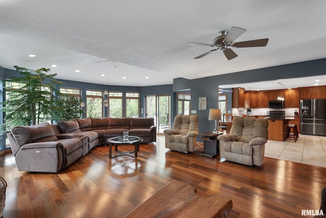 living room with a ceiling fan, recessed lighting, and light wood finished floors