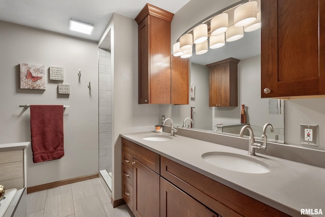 full bathroom with a sink, baseboards, and double vanity