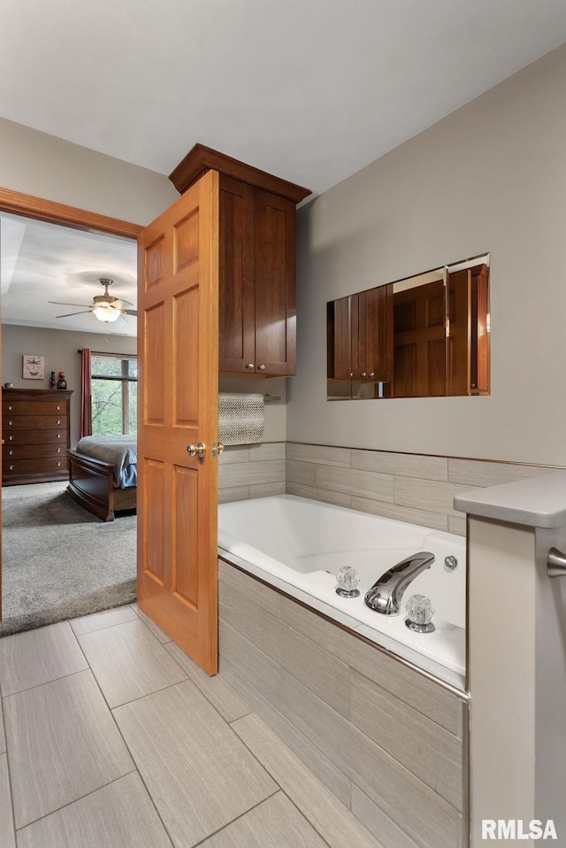 bathroom featuring ceiling fan and a bath
