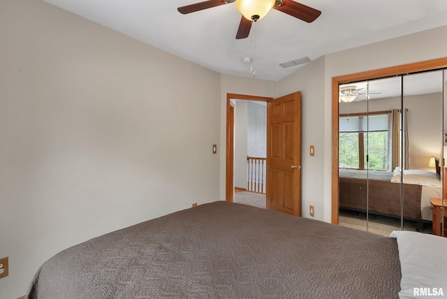 unfurnished bedroom with a closet, carpet floors, a ceiling fan, and visible vents