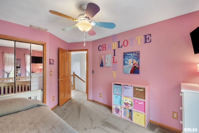 bedroom featuring a closet, visible vents, baseboards, ceiling fan, and carpet