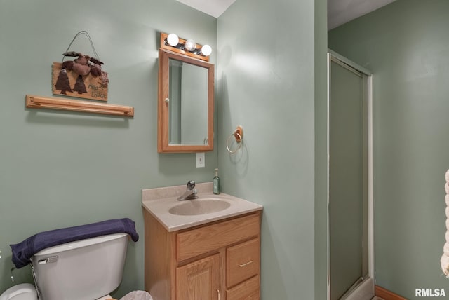 full bath with vanity, a stall shower, and toilet