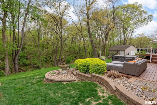 view of yard featuring an outdoor structure, a hot tub, and a wooden deck