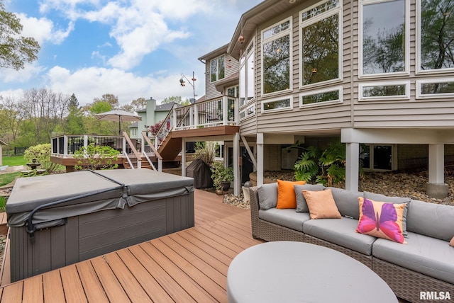 wooden terrace featuring stairs, a hot tub, and outdoor lounge area