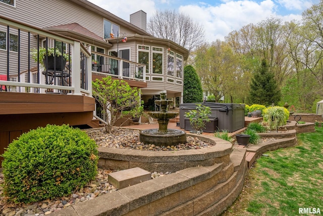 view of yard featuring a hot tub and a wooden deck