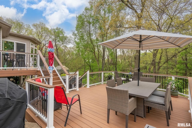 wooden deck featuring stairs and outdoor dining area