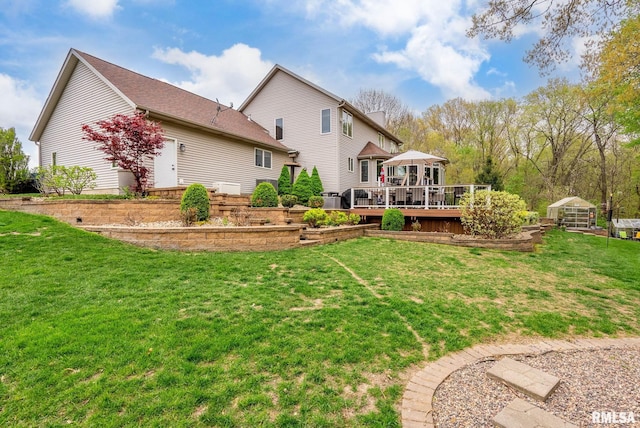 back of house featuring a lawn, a wooden deck, and a gazebo