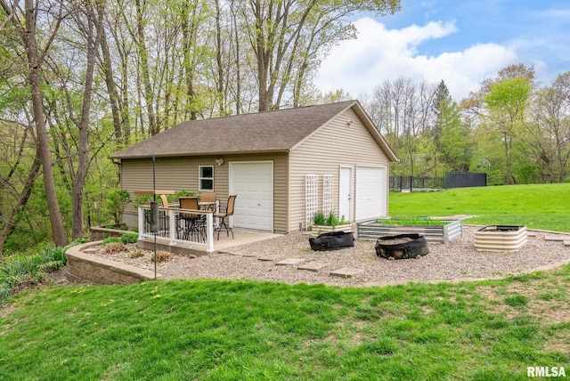 detached garage featuring fence