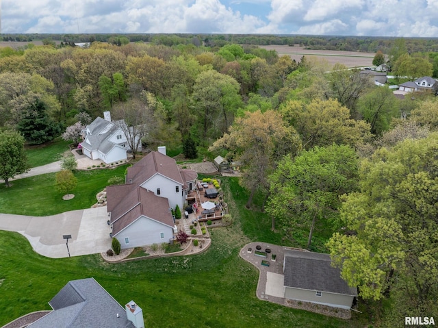 drone / aerial view featuring a residential view and a wooded view