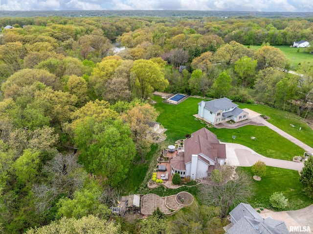 birds eye view of property with a wooded view