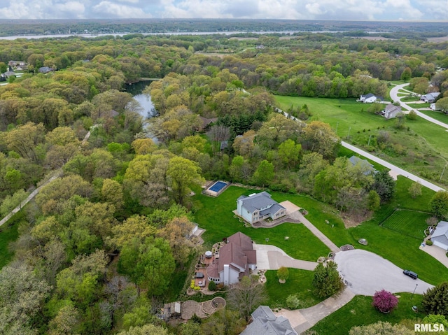 birds eye view of property with a view of trees