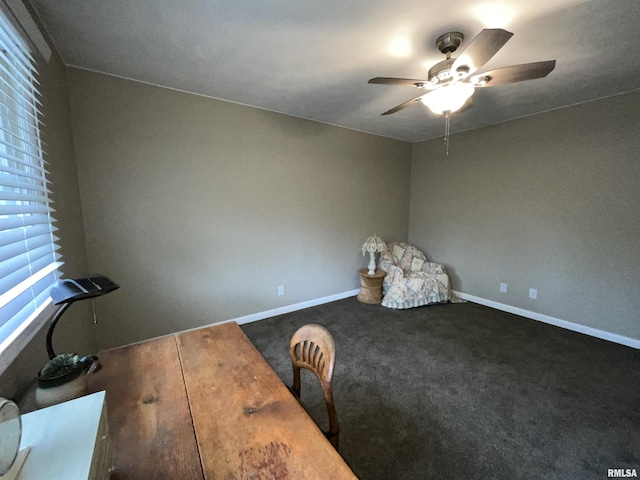 unfurnished office featuring a ceiling fan, baseboards, and carpet