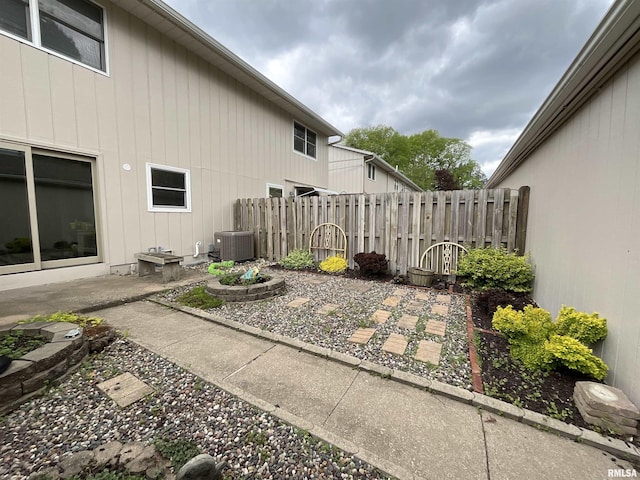 exterior space with central air condition unit, a patio, and fence