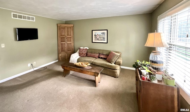 living area featuring baseboards, carpet, and visible vents