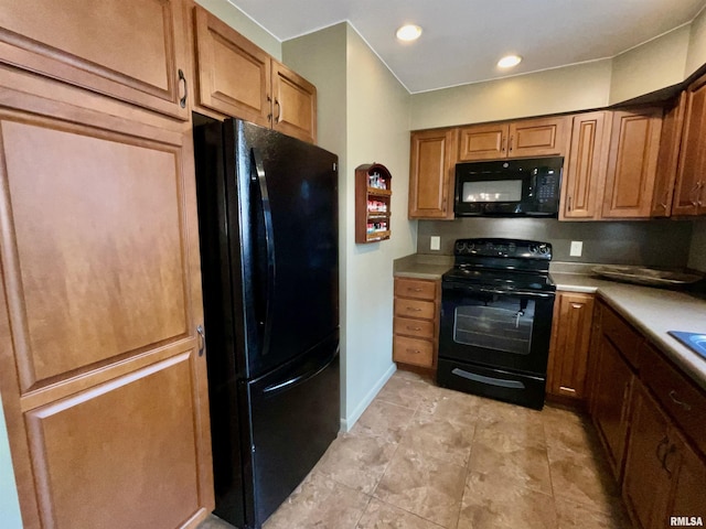kitchen with brown cabinetry, baseboards, recessed lighting, light countertops, and black appliances