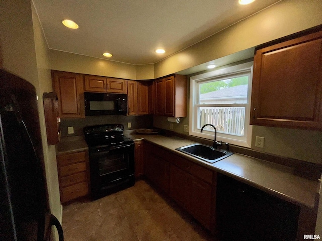 kitchen featuring recessed lighting, a sink, and black appliances