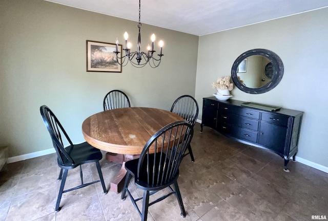 dining room with an inviting chandelier and baseboards