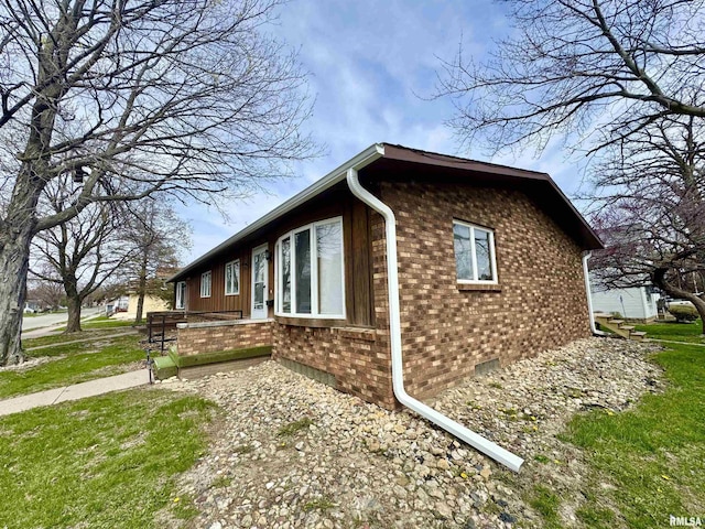 view of side of property featuring brick siding