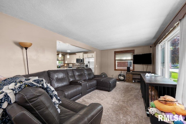 carpeted living room with a textured ceiling