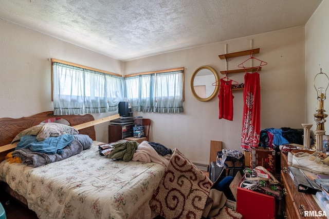 bedroom with multiple windows and a textured ceiling