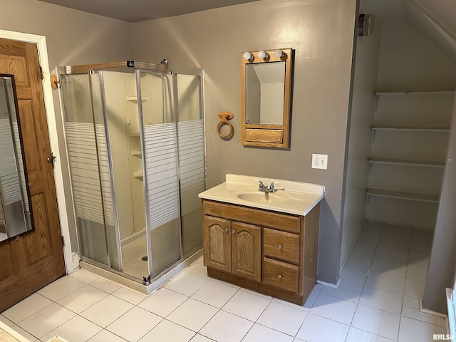 bathroom with tile patterned floors, vanity, a closet, and a stall shower