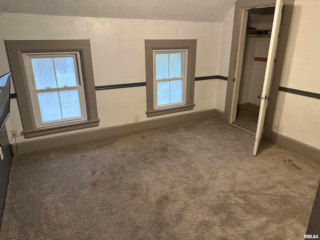 unfurnished bedroom featuring carpet floors and a closet