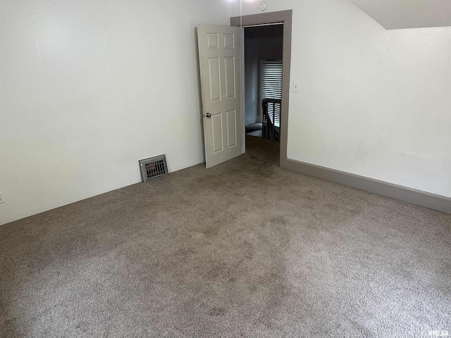 unfurnished room featuring visible vents and carpet floors
