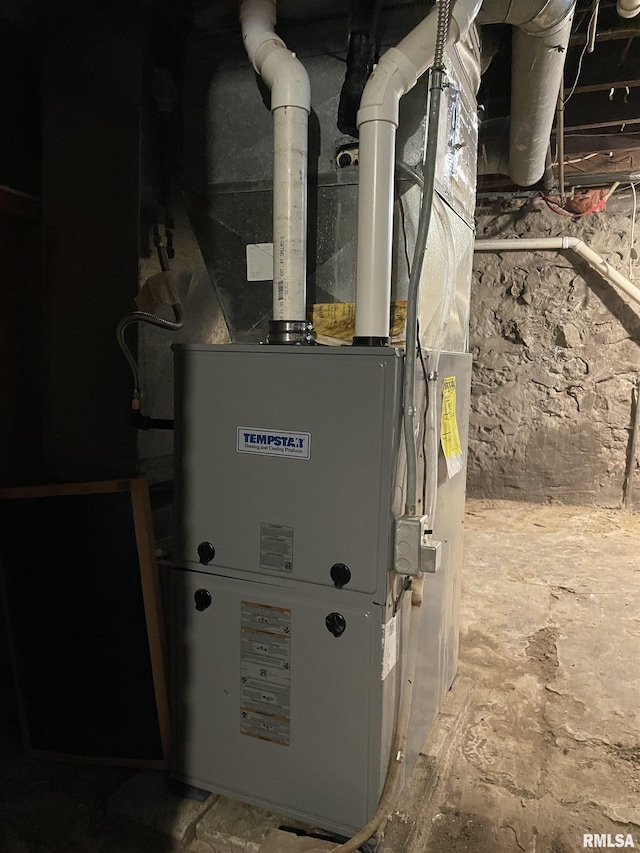 utility room featuring heating unit