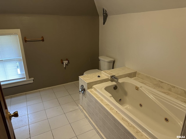 full bathroom with a tub with jets, toilet, and tile patterned floors
