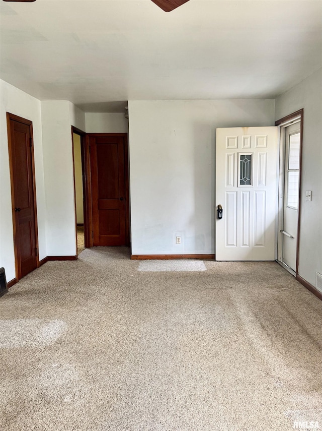 unfurnished room featuring baseboards, ceiling fan, and carpet floors