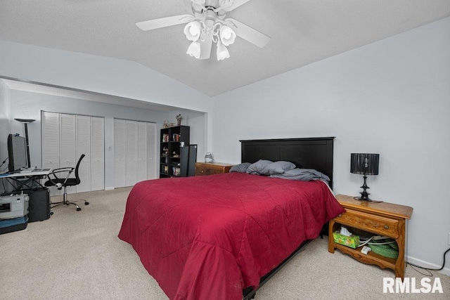 2303 Pinehurst St, Bettendorf, IA 52722 - carpeted bedroom featuring vaulted ceiling, a ceiling fan, and multiple closets
