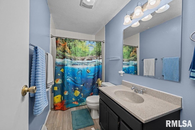 2303 Pinehurst St, Bettendorf, IA 52722 - bathroom featuring vanity, wood finished floors, toilet, a textured ceiling, and curtained shower