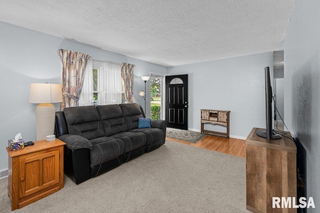 2303 Pinehurst St, Bettendorf, IA 52722 - living area with a textured ceiling, baseboards, and wood finished floors