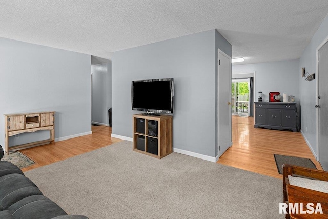 2303 Pinehurst St, Bettendorf, IA 52722 - living room with wood finished floors, baseboards, carpet flooring, and a textured ceiling