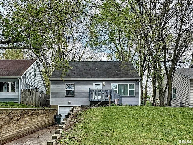 view of front of house featuring a deck, an attached garage, fence, stairway, and a front lawn