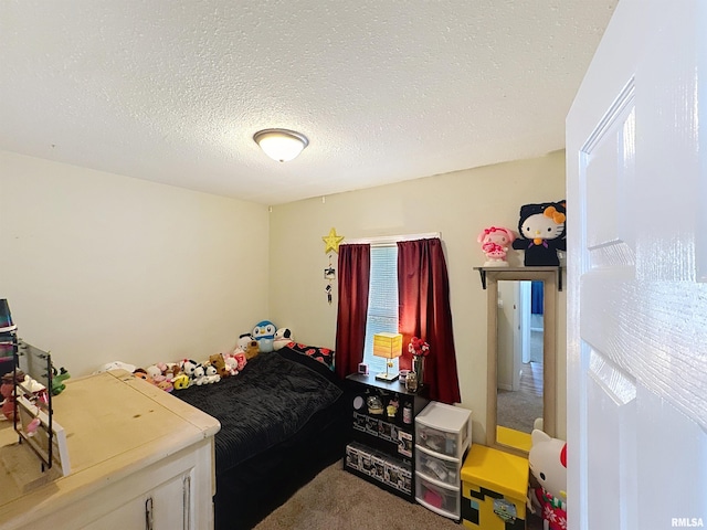 bedroom featuring a textured ceiling and carpet floors