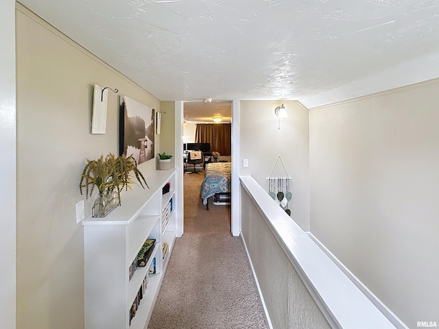 hallway featuring an upstairs landing and carpet floors