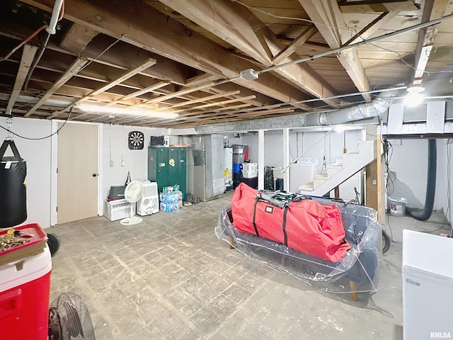 unfinished below grade area with heating unit, washer and clothes dryer, and stairway