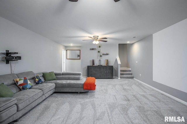 carpeted living area with visible vents, baseboards, a ceiling fan, and stairs