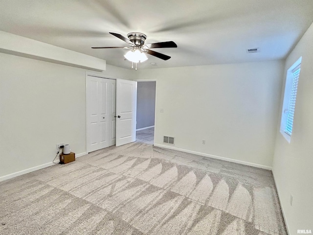 1609 Parkview Ln, Davenport, IA 52807 - unfurnished bedroom featuring carpet floors, baseboards, ceiling fan, and a closet