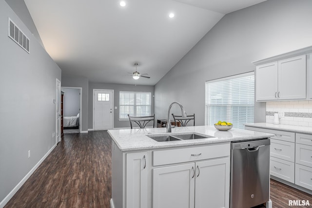 kitchen with a ceiling fan, lofted ceiling, stainless steel dishwasher, visible vents, and a sink