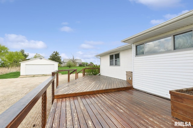 wooden terrace featuring an outdoor structure and a detached garage