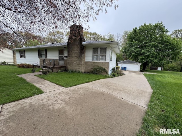 4528 5th St Unit B, East Moline, IL 61244 - ranch-style home featuring a chimney, an outbuilding, a detached garage, and a front lawn