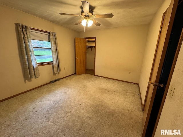 4528 5th St Unit B, East Moline, IL 61244 - unfurnished bedroom with light colored carpet, baseboards, and a ceiling fan