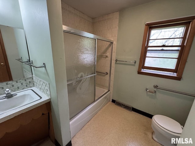 4528 5th St Unit B, East Moline, IL 61244 - bathroom featuring toilet, vanity, and enclosed tub / shower combo