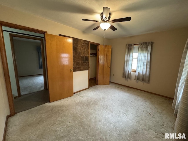 4528 5th St Unit B, East Moline, IL 61244 - unfurnished bedroom featuring a closet, baseboards, light colored carpet, and ceiling fan
