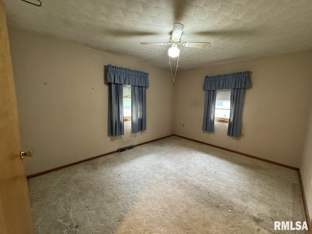 4528 5th St Unit B, East Moline, IL 61244 - empty room with carpet flooring, ceiling fan, baseboards, and a textured ceiling