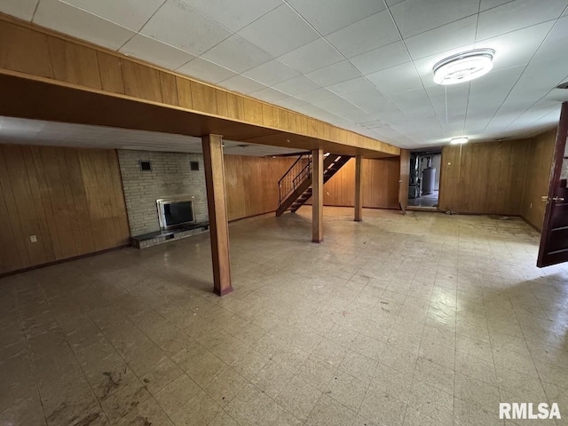 4528 5th St Unit B, East Moline, IL 61244 - finished basement with wood walls, a brick fireplace, tile patterned floors, and stairway
